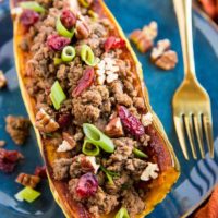 Stuffed Delicata Squash with Ground Beef, Cranberries and Pecans is a healthy dinner recipe that is paleo, whole30 and nutritious. Plus, it's easy to make!