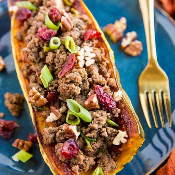 Stuffed Delicata Squash with Ground Beef, Cranberries and Pecans is a healthy dinner recipe that is paleo, whole30 and nutritious. Plus, it's easy to make!