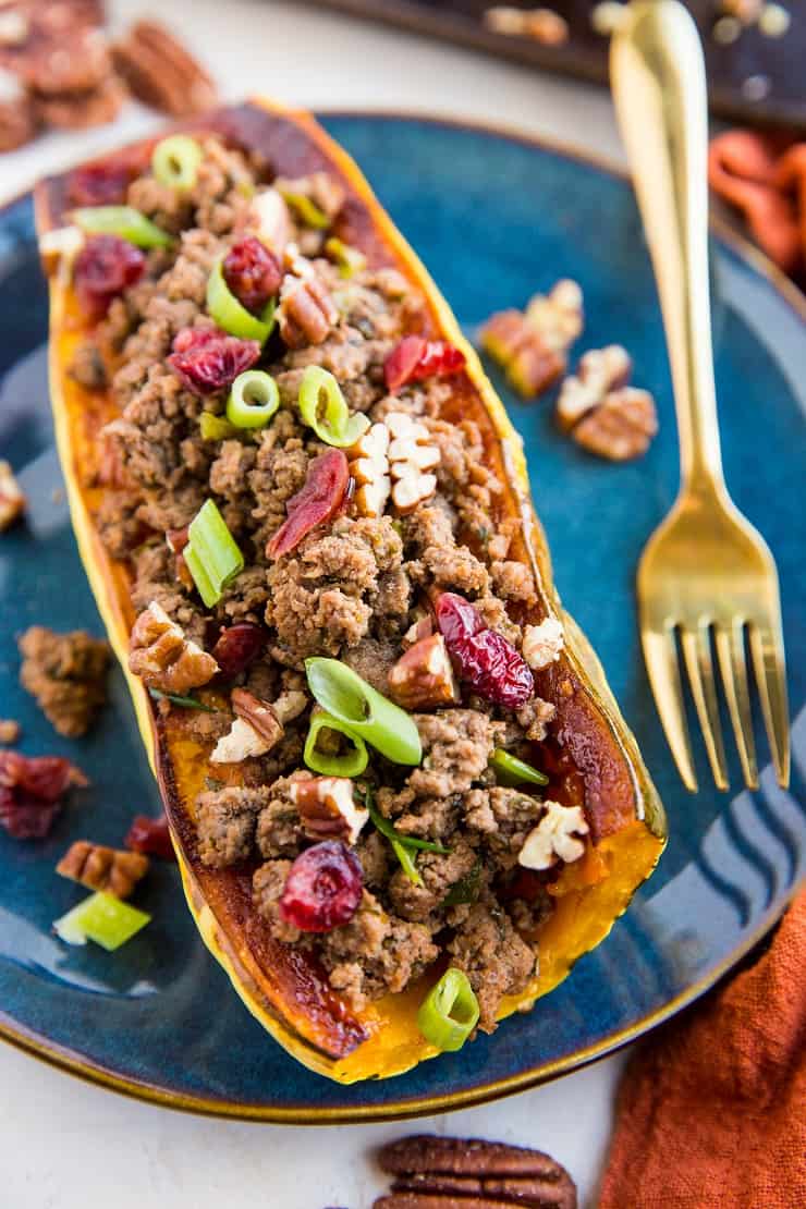 Stuffed Delicata Squash with Ground Beef, Cranberries and Pecans is a healthy dinner recipe that is paleo, whole30 and nutritious. Plus, it's easy to make!