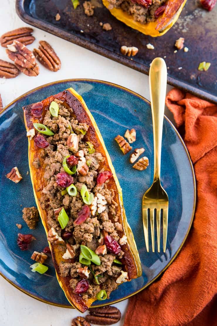 Stuffed Delicata Squash with ground beef, cranberries, pecans and green onion - a healthy dinner recipe that can be made any night of the week. Paleo, whole30, nutritious