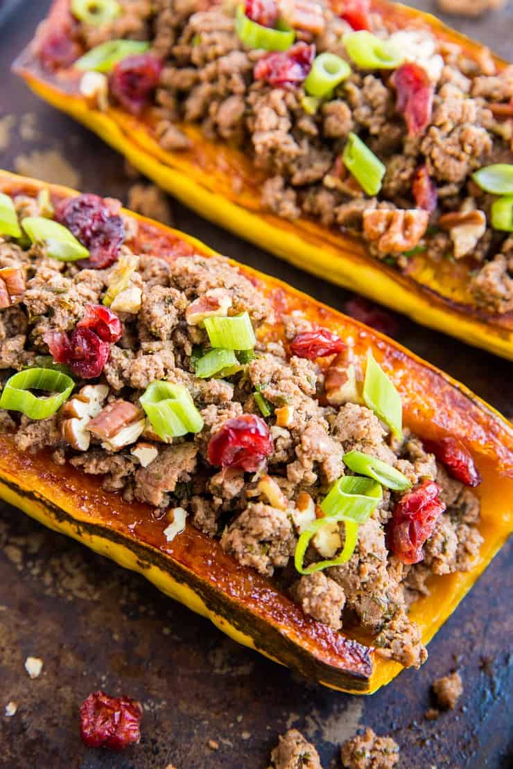 Ground Beef Stuffed Delicata Squash with pecans, dried cranberries, onion, and garlic - a healthy paleo, whole30 dinner recipe