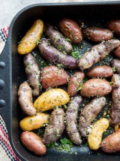 Garlic Roasted Potatoes - an easy recipe for herby garlicky fingerling potatoes with the perfect crisp. A delightful side dish to any meal!