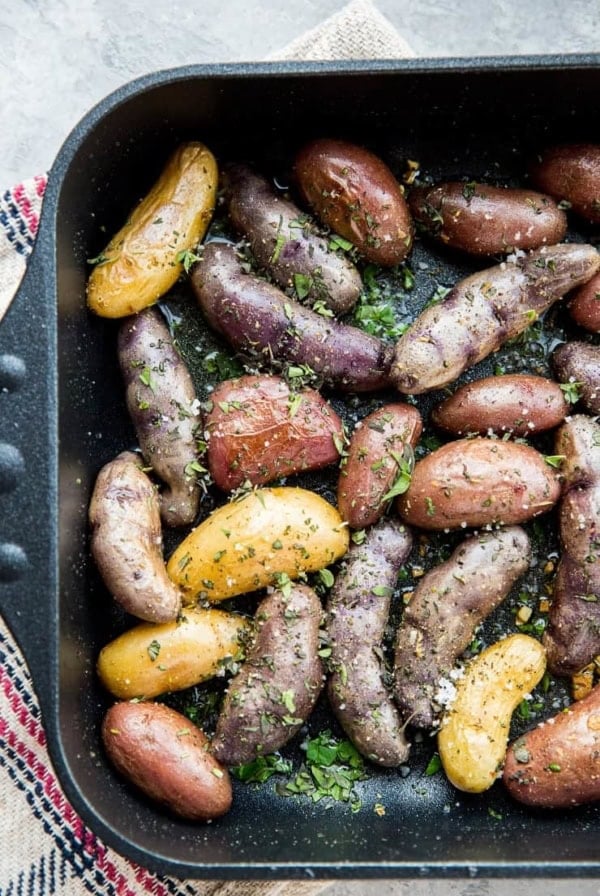 Garlic Roasted Potatoes - an easy recipe for herby garlicky fingerling potatoes with the perfect crisp. A delightful side dish to any meal!