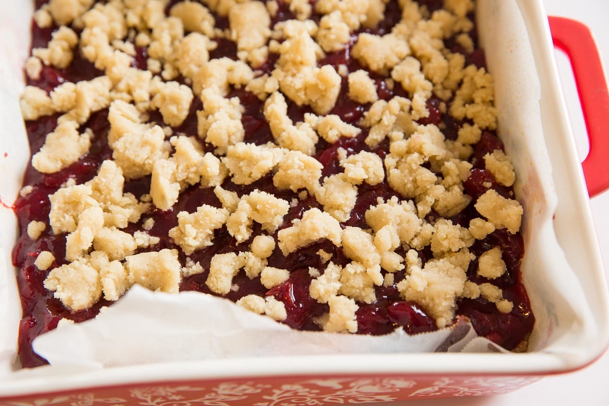 Baking dish of cranberry crumb bars ready to go into the oven.