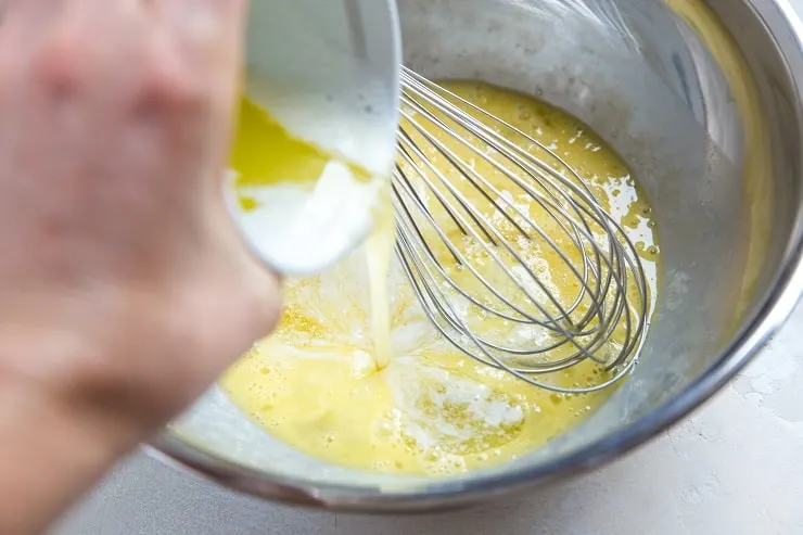 Mixing butter and eggs in a mixing bowl to make biscuits