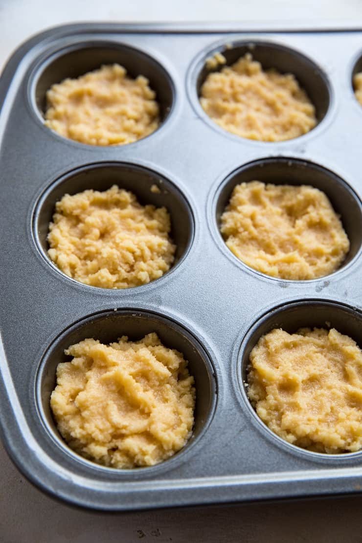 Fill a muffin tray with biscuit dough