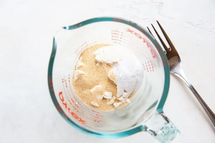 Coconut flour for grain-free biscuits in a measuring cup