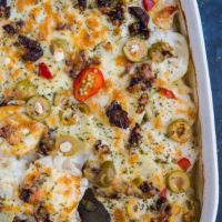 Mediterranean Scalloped Potatoes with sun-dried tomatoes, olives, and roasted bell peppers. A unique spin on classic scalloped potatoes for an amazing side dish!