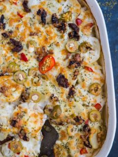 Mediterranean Scalloped Potatoes with sun-dried tomatoes, olives, and roasted bell peppers. A unique spin on classic scalloped potatoes for an amazing side dish!