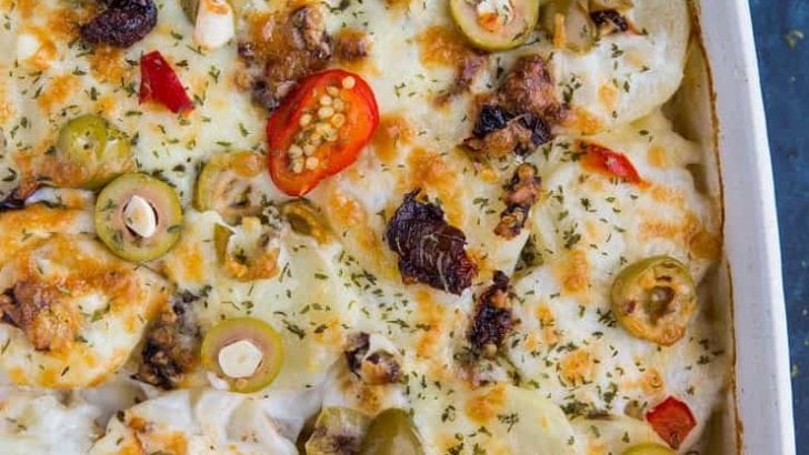Mediterranean Scalloped Potatoes with sun-dried tomatoes, olives, and roasted bell peppers. A unique spin on classic scalloped potatoes for an amazing side dish!