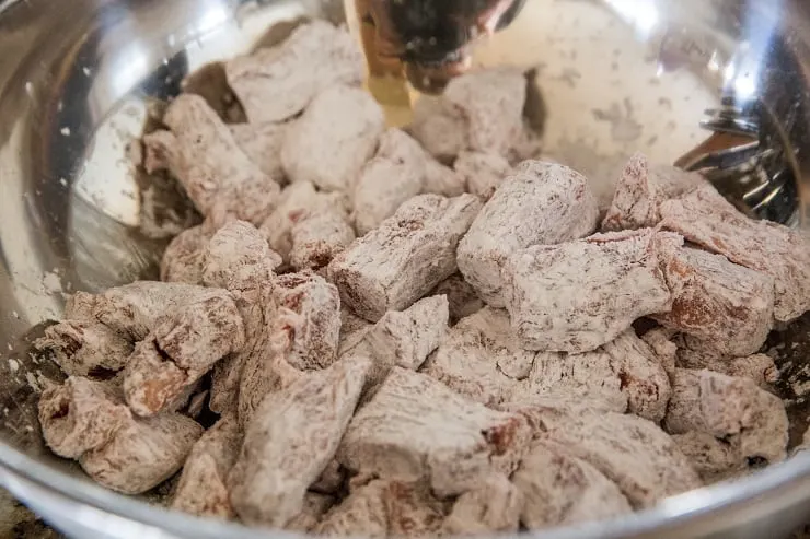 Beef and tapioca flour in a mixing bowl to make mongolian beef