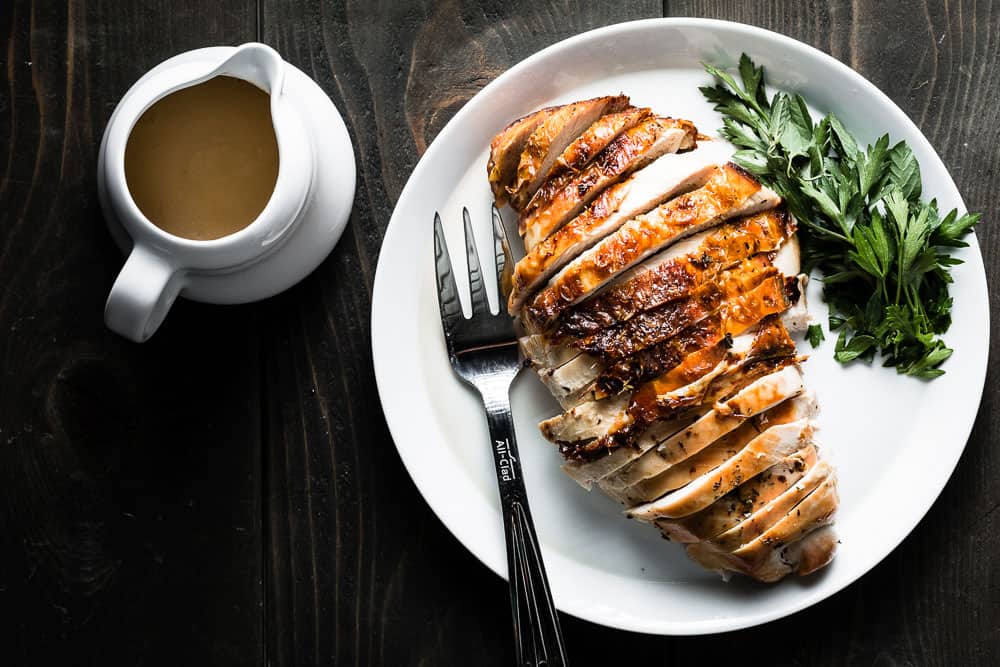 Herb Roasted Turkey Breast from Salt and Pepper Kitchen - Roasting just the turkey breast is a delicious and pain-free alternative to cooking a whole turkey. Brining it first guarantees tons of flavor and juicy turkey in every bite!!