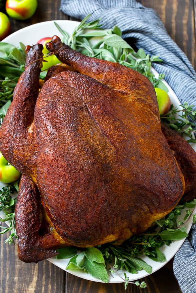 Smoked Turkey Recipe from Dinner at the Zoo- This smoked turkey recipe is a whole turkey that’s coated in homemade spice rub then slow smoked to tender and juicy perfection. A super easy and impressive holiday main course that won’t take up any oven space!