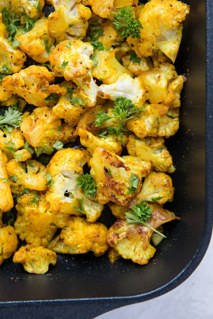 Turmeric Roasted Cauliflower with garlic and sriracha - an easy healthy side dish that is paleo, vegan, whole30, and keto