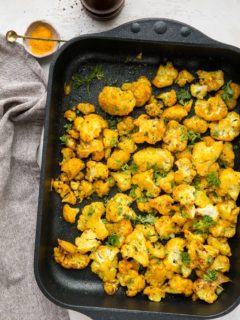 Turmeric Roasted Cauliflower - an easy superfood side dish with cauliflower, turmeric, garlic powder, liquid aminos and sriracha for a flavorful vegan, paleo, keto side dish