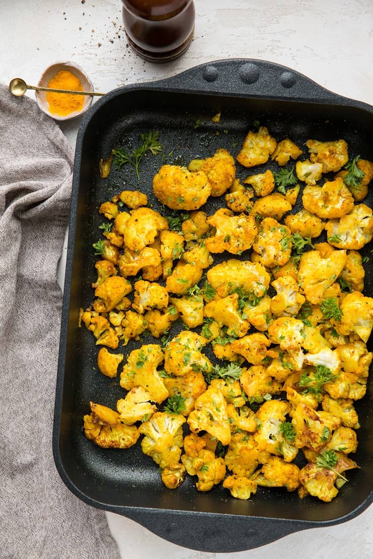 Turmeric Roasted Cauliflower - an easy superfood side dish with cauliflower, turmeric, garlic powder, liquid aminos and sriracha for a flavorful vegan, paleo, keto side dish