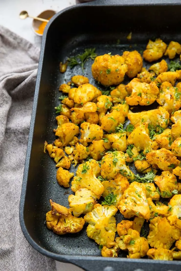 Turmeric Roasted Cauliflower with garlic and sriracha - an easy healthy side dish that is paleo, vegan, whole30, and keto