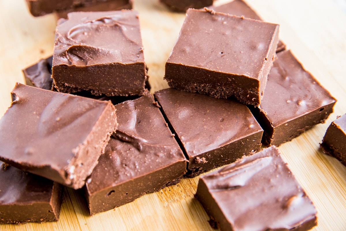 Low-Carb Fudge Recipe - easy chocolate fudge made sugar-free. Horizontal photo of fudge on a cutting board.