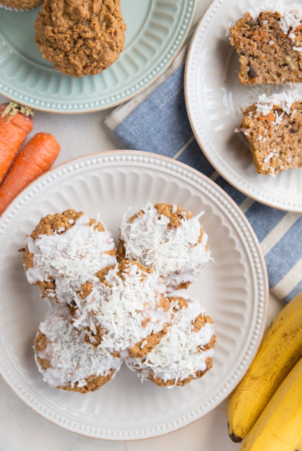 Hand holding half of a carrot cake muffin