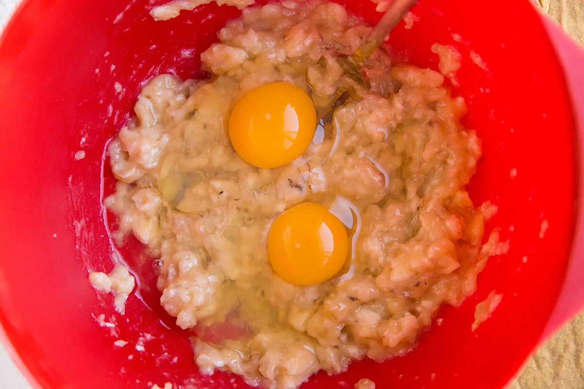 Mixing bowl with mashed banana and eggs