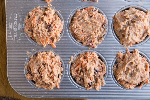 Muffin tray with muffin batter in the holes