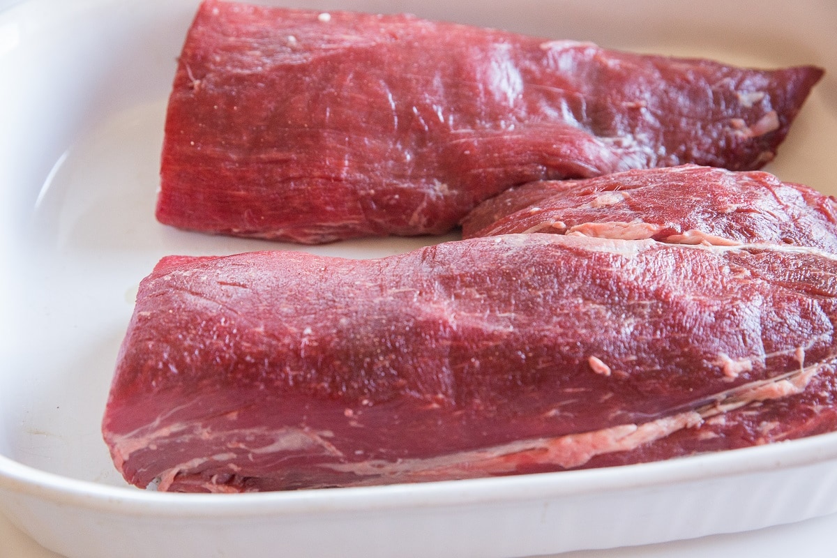 Whole beef tenderloin roast in a casserole dish