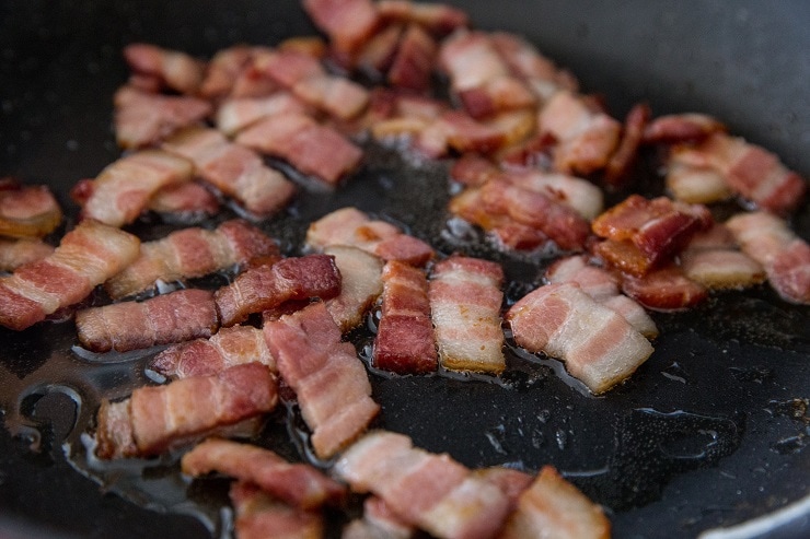 chopped bacon cooking in a skillet