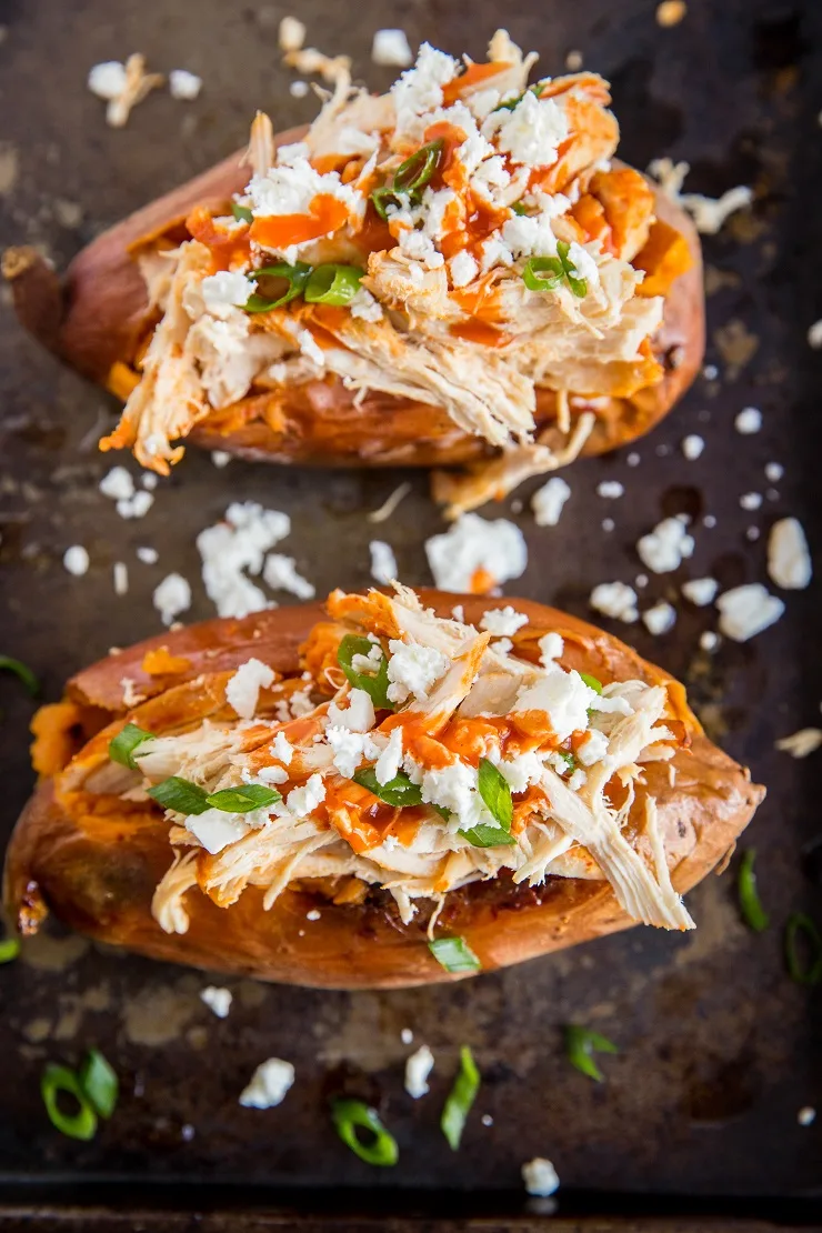 Shredded Buffalo Chicken Stuffed Sweet Potatoes with feta and green onion - an easy, simple healthy dinner recipe loaded with protein and complex carbs