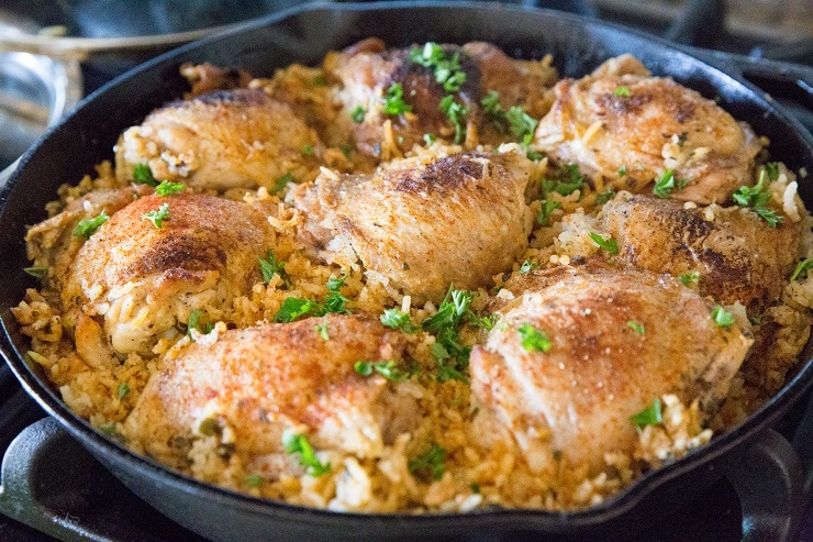Finished arroz con pollo in a skillet on the stove top