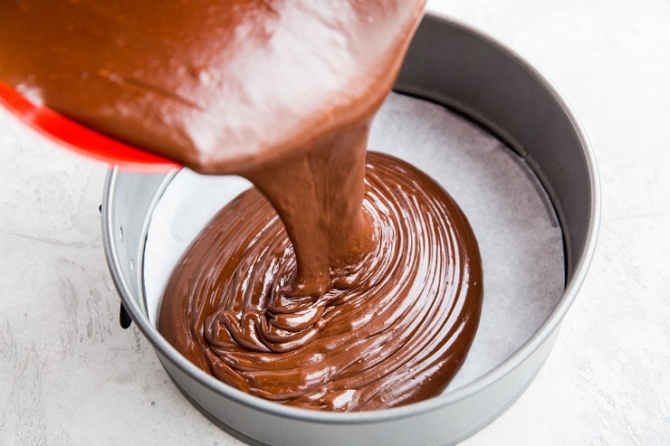 Keto cake batter pouring into a cake pan