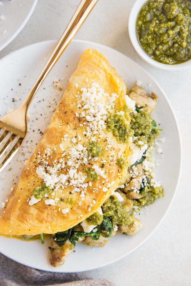 Easy Chicken Omelette with pesto sauce, spinach, and feta cheese. Nutritious and delicious!