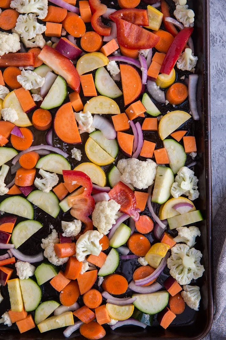 Vegetables for roasted vegetable bowls on a baking sheet