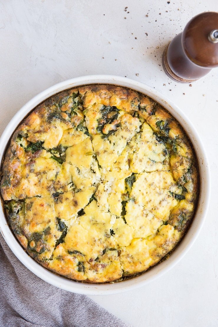 Crustless Quiche Recipe with spinach, bacon, onions, and feta cheese.