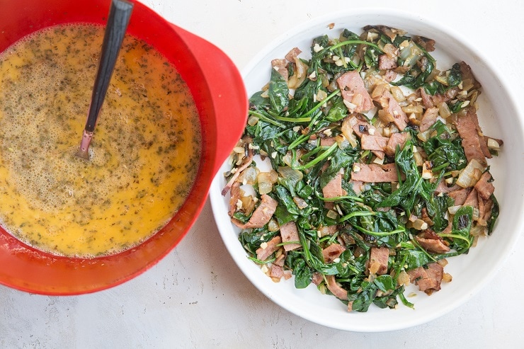 Transfer veggies and bacon to a pie dish and whisk the eggs in a mixing bowl