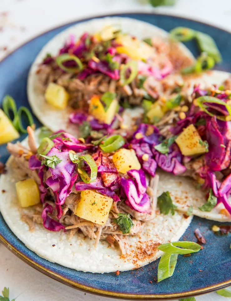 Shredded Pineapple Pork Tacos with cabbage slaw and green onion