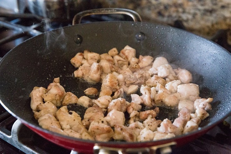 Chicken cooking in a skillet