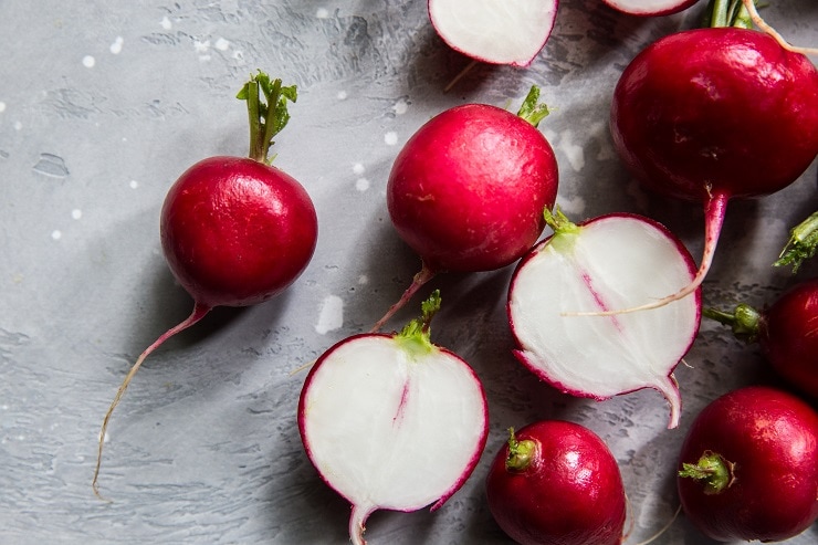 Raw radishes on a backdrop