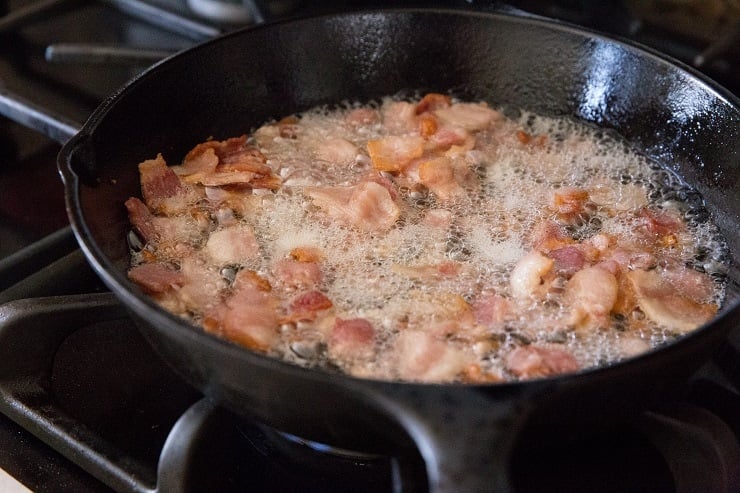 Chop the bacon and cook it in a cast iron skillet until crispy