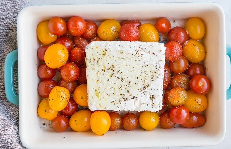 Add the feta cheese to the casserole dish and drizzle with avocado oil, sea salt, and pepper