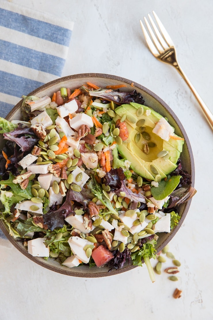 Fully Loaded Salad with chicken, avocado, pumpkin seeds, pecans, carrots, tomatoes, and more!