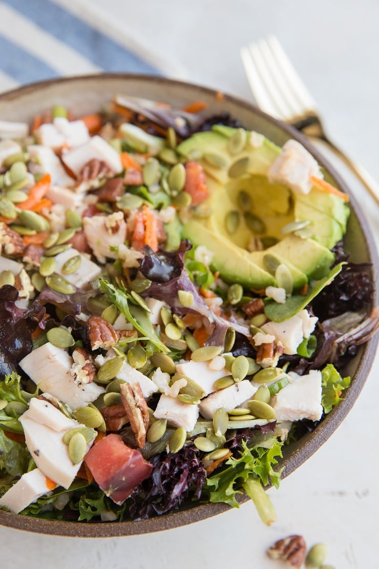 Fully Loaded Salad with chicken, avocado, pumpkin seeds, pecans, carrots, tomatoes, and more!