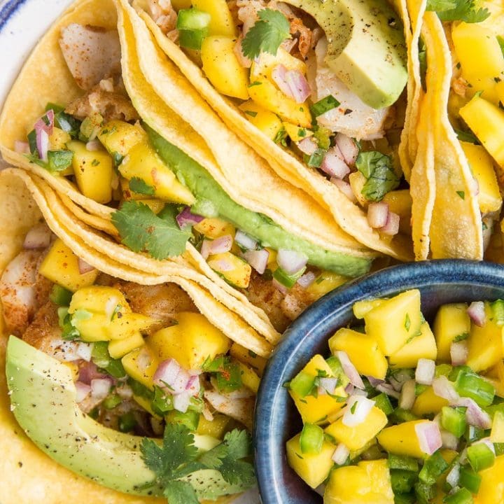 Easy Fish Tacos with Mango Salsa - a quick recipe for a fresh and delicious healthy taco using oven-baked cod and avocado