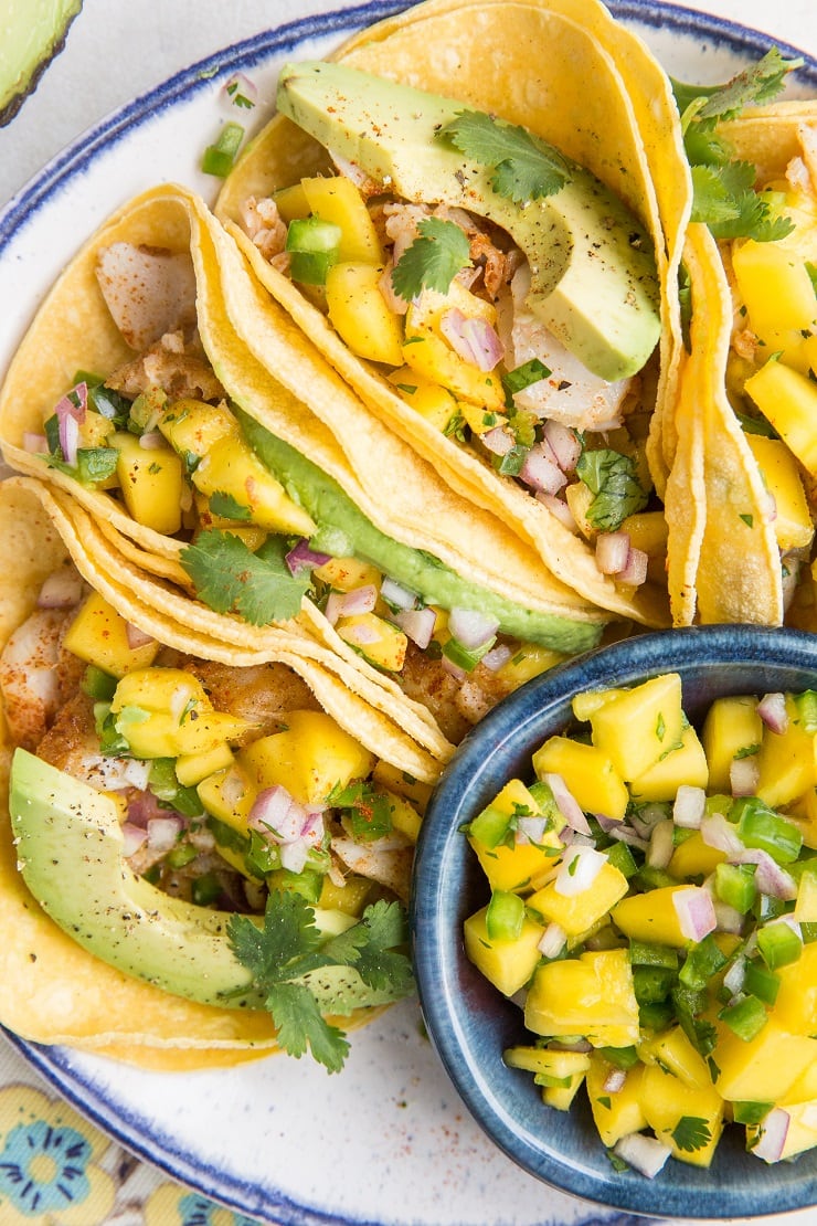 Easy Fish Tacos with Mango Salsa - a quick recipe for a fresh and delicious healthy taco using oven-baked cod and avocado