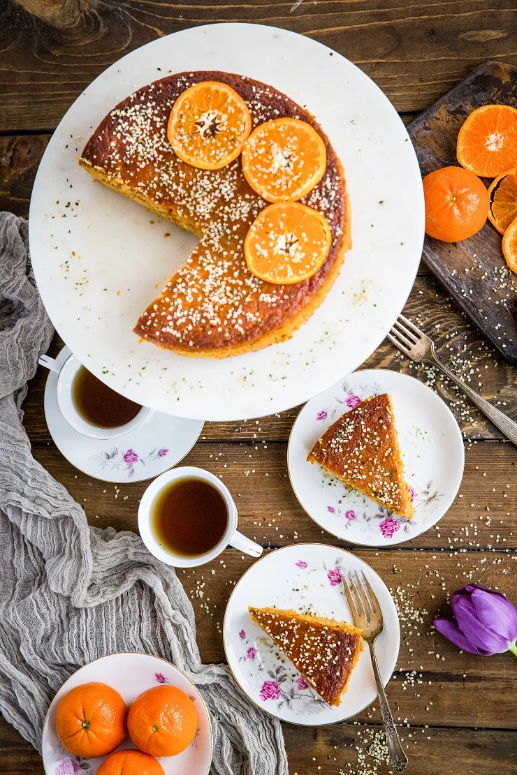 top down photo of clementine cake with two slices on two plates