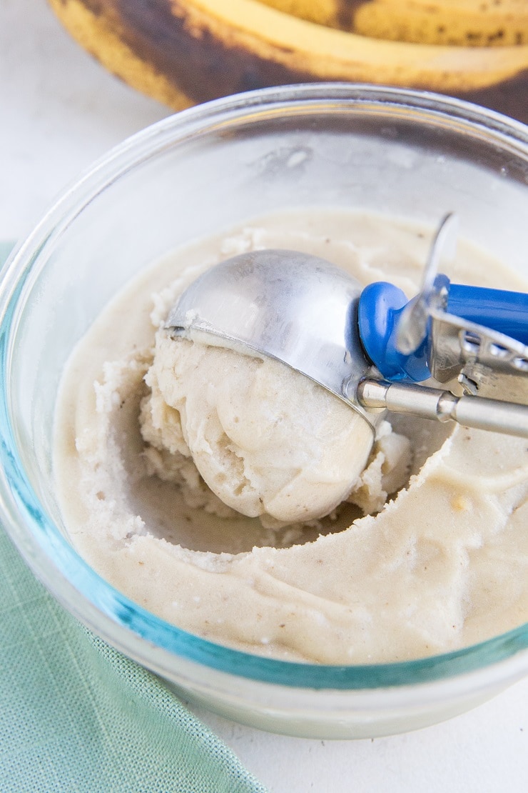 Scooping ice cream out of a storage container