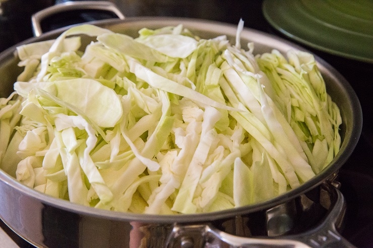 Add sliced cabbage to the skillet