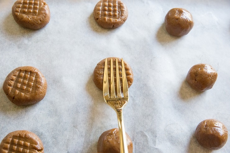 Press balls of almond butter dough with a fork to shape them