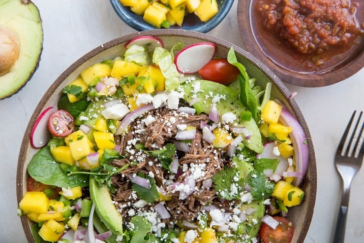 Instant Pot Shredded Beef Taco Salad with mango salsa, avocado and more! A healthy, satisfying entrée salad recipe.