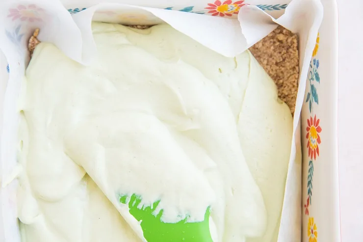 Pour the key lime pie filling over the pie crust and freeze