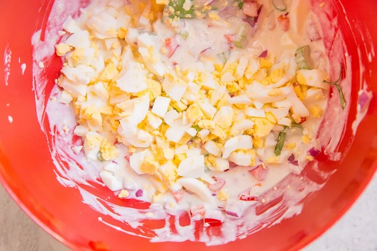 Ingredients for macaroni salad in a mixing bowl